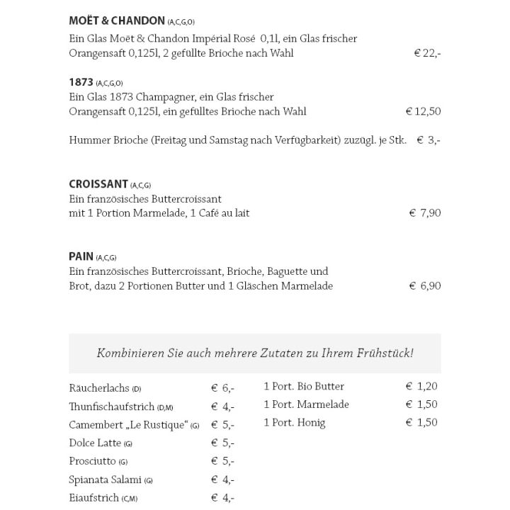 Eine deutsche Frühstückskarte mit Sekt, Croissants, Brot, Butter, Marmelade, Honig, Käse und Getränken mit Preisangaben.